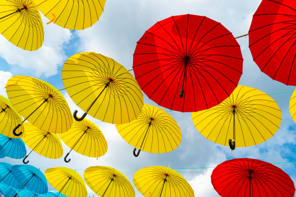 istock Bright color decorative umbrellas hanging bottom-up sky background 1436696983