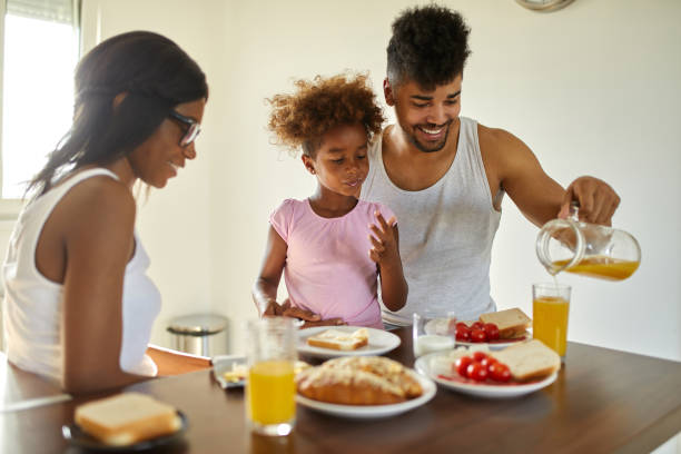 istock Young happy family having breakfast at home 1436699848