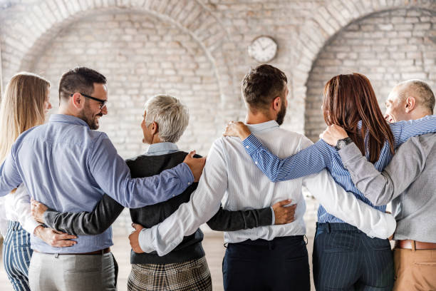 istock Back view of embraced business team talking in the office. 1436702399