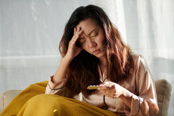 istock Woman Suffering from Severe Headache 1436705104