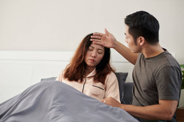 istock Husband Touching Forehead of Sick Wife 1436705151