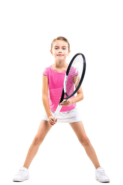 joven tenista femenina con atuendo rosa. niña posando con raqueta y pelota aisladas sobre fondo blanco. - tennis child childhood sport fotografías e imágenes de stock