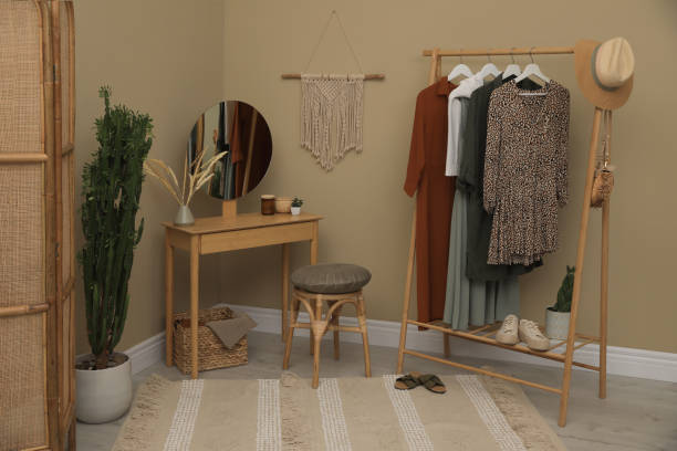 istock Modern dressing room interior with clothing rack, wooden table and mirror 1436708552
