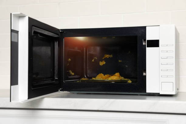 istock Dirty microwave oven on white countertop indoors 1436709837