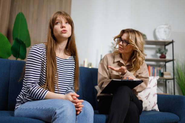 istock Young depressed woman shares her problems with a psychologist 1436710622