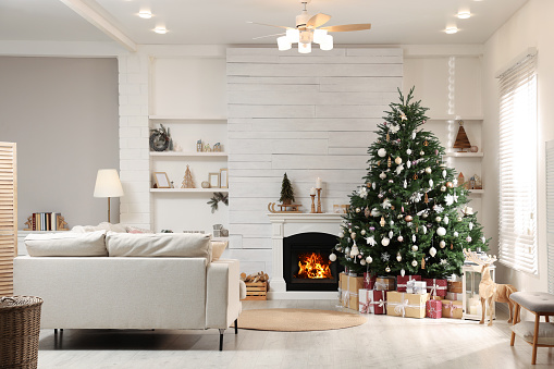 Festive living room interior with beautiful Christmas tree