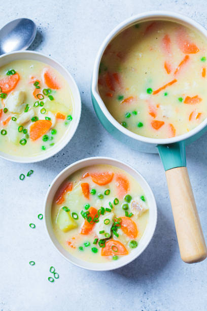 istock Fish cod chowder soup with green peas, potatoes and carrots in white bowl. 1436711735