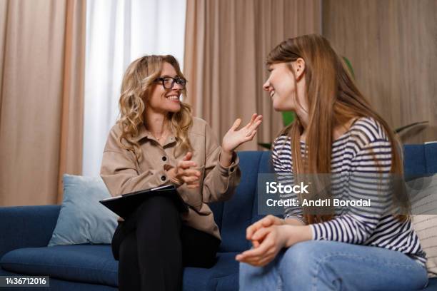 Encouraging Therapist Talks With Young Woman Stock Photo - Download Image Now - Mental Health Professional, Psychotherapy, Mental Health