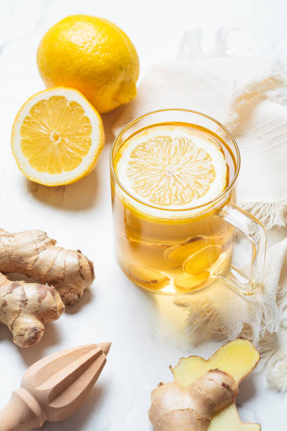 Ginger tea in glass mug. Winter vitamin drink for immunity boosting. Ginger tea in a glass mug. Winter vitamin drink for immunity boosting. ginger health stock pictures, royalty-free photos & images