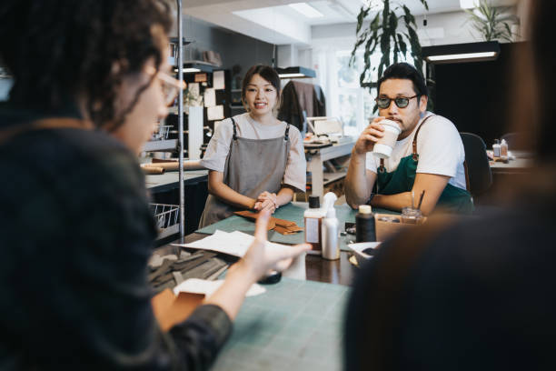 istock Team of leather crafters discussing work 1436712431