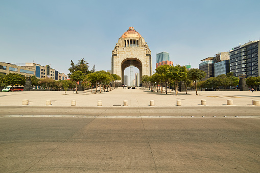 The famous Monument to the Revolution at the Republic Square of Mexico City under a blue sky