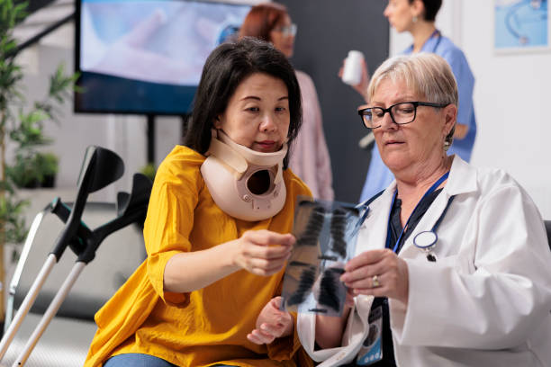 istock Physician consulting patient with cervical neck collar 1436714703