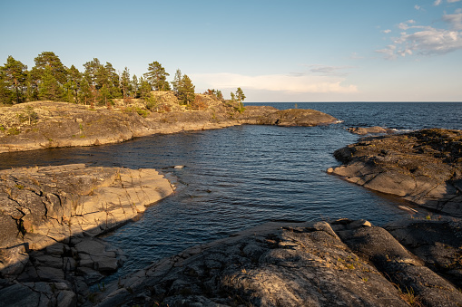 Rocky shore overlooking the Ladoga lakes in Karelia at sunset.