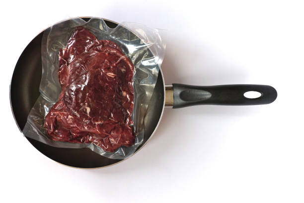 istock Vacuumed raw meat in pan on white background. 1436715958