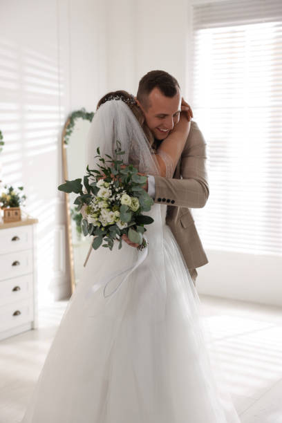 istock Happy groom and bride hugging indoors. Wedding day 1436716133