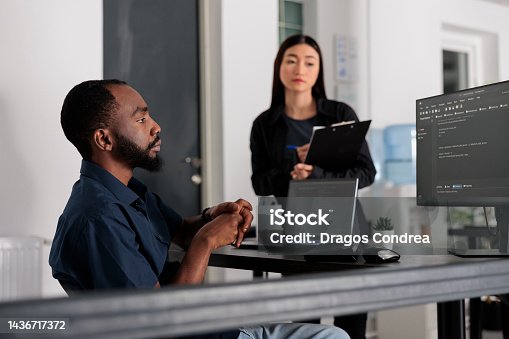 istock Multi ethnic system engineers collaborating on programming project compiling algorithm 1436717372