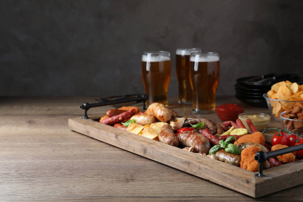 istock Set of different tasty snacks and beer on wooden table, space for text 1436717631