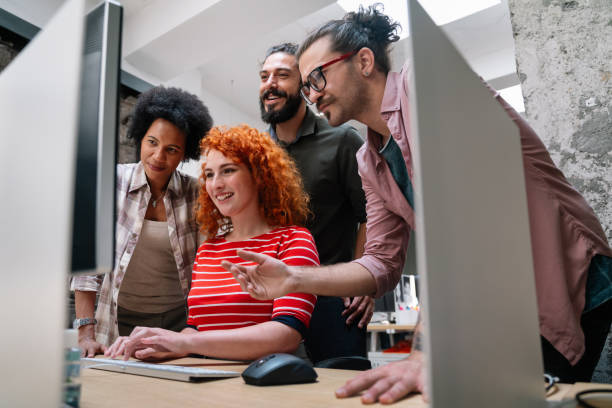 istock Smiling diverse colleagues gather in boardroom brainstorm discuss financial statistics together 1436717693