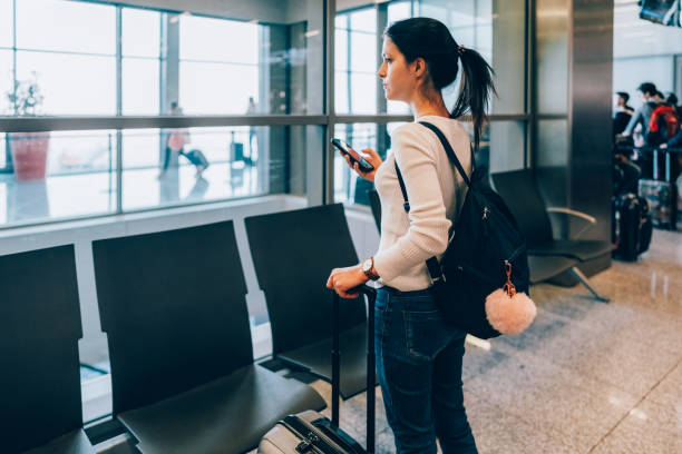 istock Passenger at the airport using smart phone 1436719971