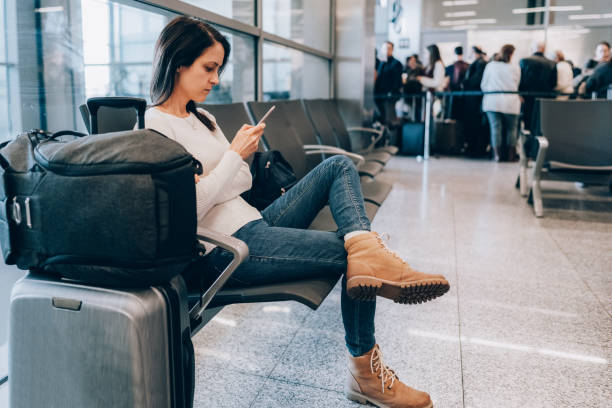 istock Passenger at the airport using smart phone 1436719994