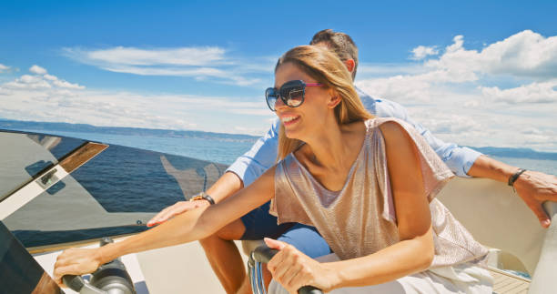 istock Couple driving luxury yacht 1436719999