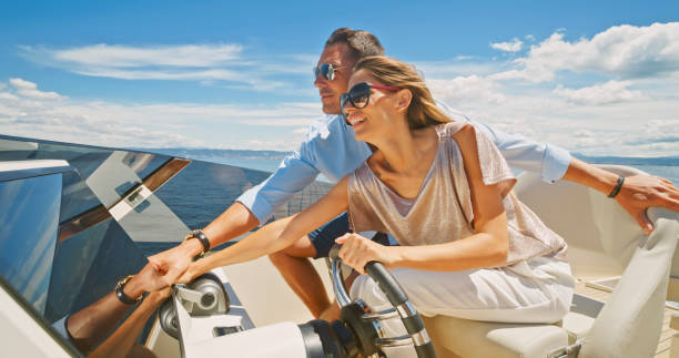 istock Couple driving luxury yacht 1436720055