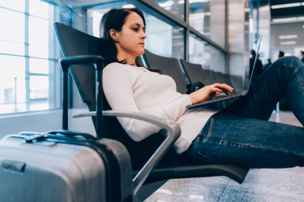 istock Passenger at the airport using laptop 1436720173