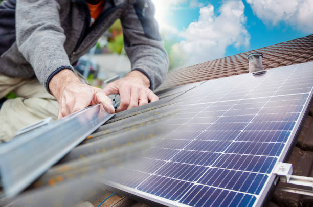 istock Roofer, worker on the rooftop. Roofing work. Solar Cell Installation. Preparation of Solar panel installation. attaching rails on construction site 1436721785