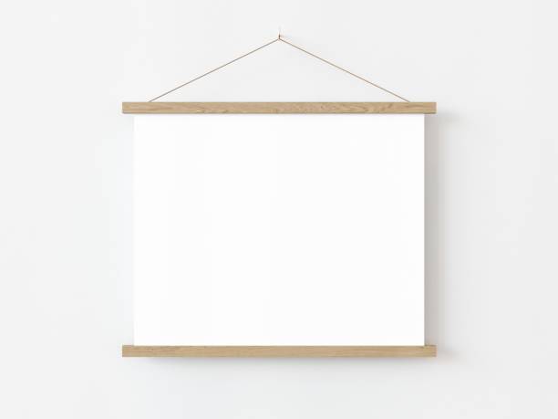 istock One square roll up poster mockup with light wood border hanging on a white wall in empty room. Isolated roll up poster mockup template on white background. 3D illustration 1436722815