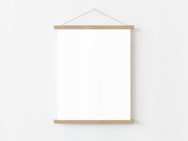 istock One vertical rectangle roll up poster mockup with light wood border hanging on a white wall in empty room. Isolated roll up poster mockup template on white background. 3D illustration 1436722830