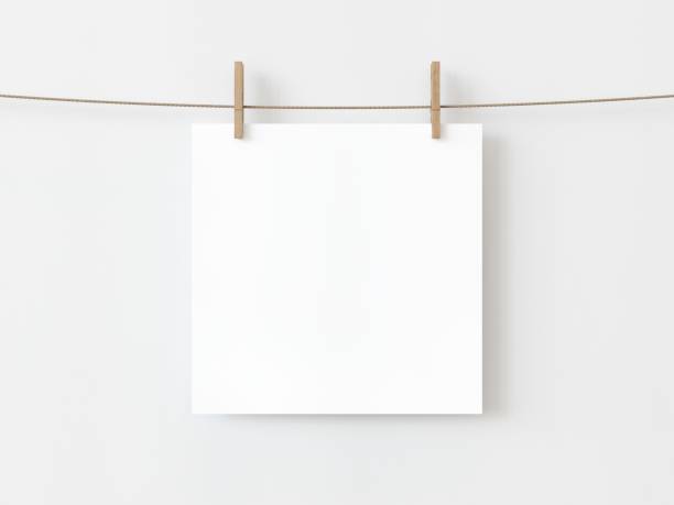 istock One blank square note paper card hanging with wooden clip or clothespin on rope string peg isolated on white backgroun. 3D illustration 1436722858