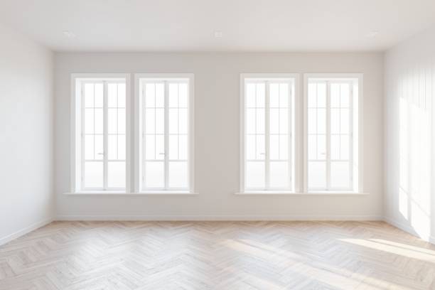istock Abstract of empty white room with four vertical windows with sunlight cast the shadow on the wall and wood laminate floor, Perspective of minimal interior design architecture. 3D illustration 1436723496