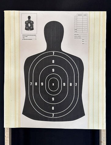 Close-up of target with numbers for shooting at rifle range. Round target with marked bulls-eye for shooting practice on range