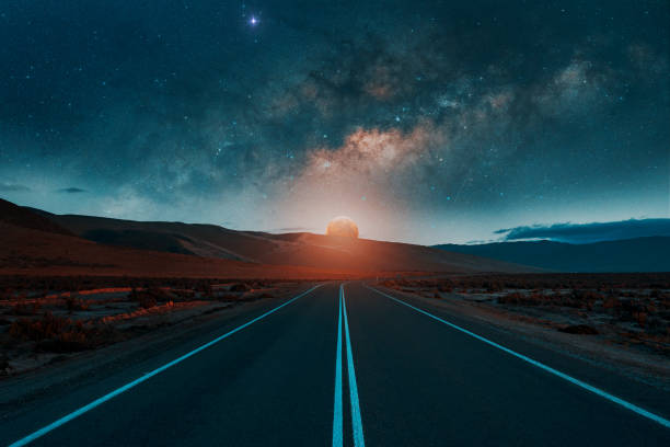 istock road in the desert with moon and milky way background 1436723584
