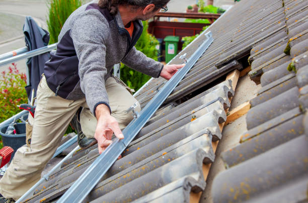 istock Roofer, worker on the rooftop. Roofing work. Solar Cell Installation. Preparation of Solar panel installation. attaching rails, hooks. scaffolding on construction site 1436724778