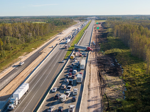 LAKE ALFRED, Fla., USA – OCT. 26, 2022: Westbound truck crossed I4 Eastbound shutting down freeway. Traffic building up. Emergency vehicles are working.