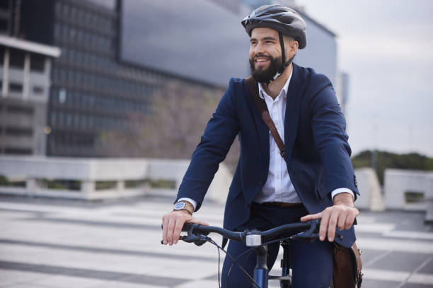 istock Young businessman riding his bike after work and smiling 1436730751