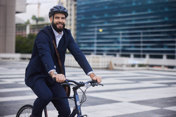 istock Smiling young businessman walking with his bike outdoors after work 1436730932