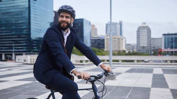istock Smiling young businessman riding on his bike outdoors after work 1436731754