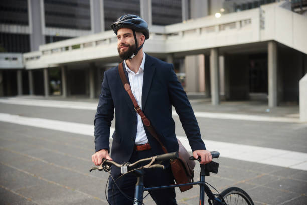 istock Smiling young businessman leaving work with his bike 1436731807