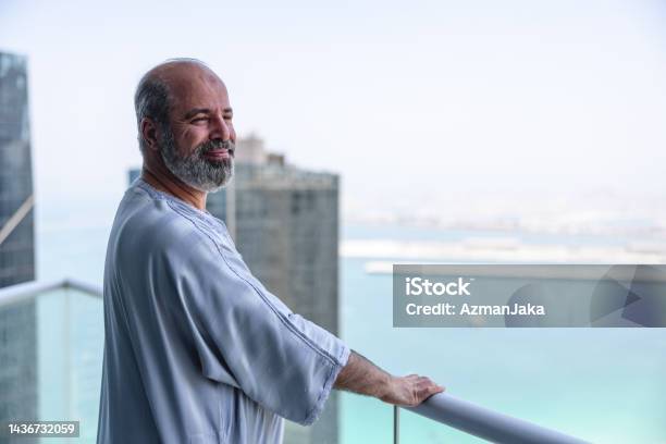 Middle Eastern Older Male Enjoying View On His Balcony Stock Photo - Download Image Now