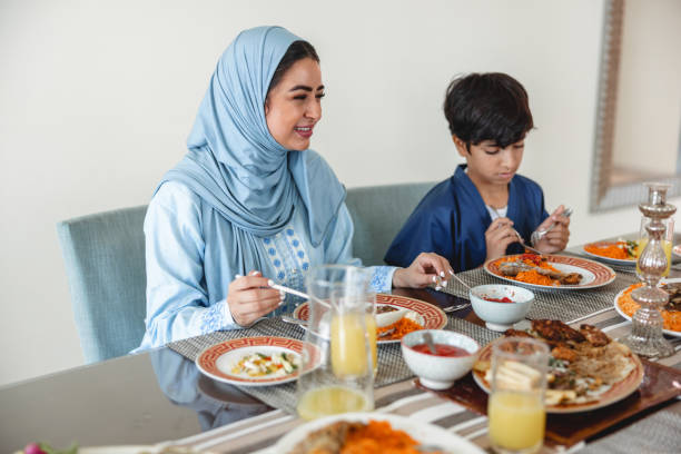 istock Middle Eastern Mother And Son Sitting Next To Each Other At Dining Table 1436732141