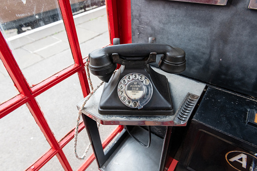 Red telephone box, public phone, in London, England, UK