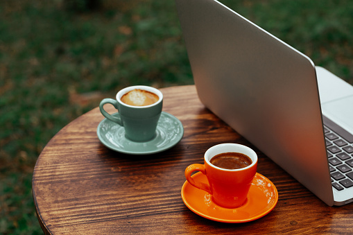 Two Espresso Coffee Cup On Working Table With Laptop