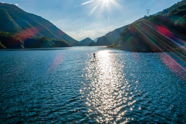 man paddling SUP in lake