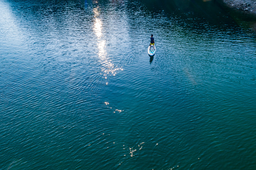 man paddling SUP in lake