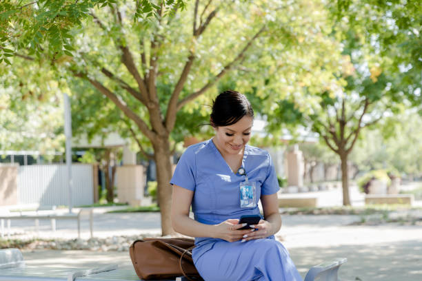 istock Female nurse sits and reads her phone 1436734451