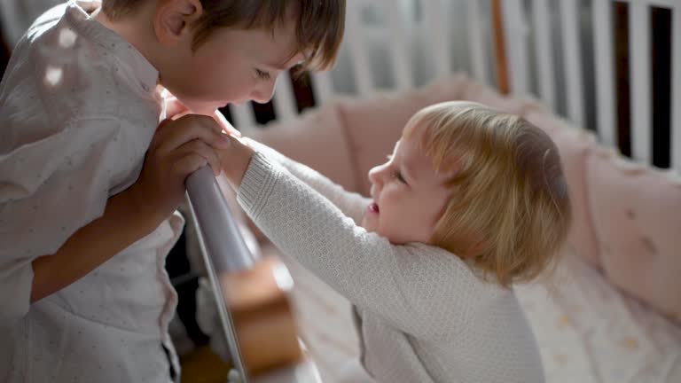 Little boy with his cute baby sister