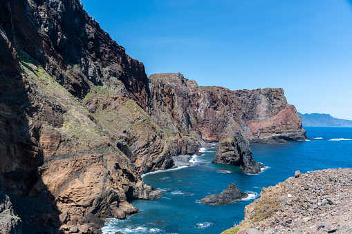 A small bay surrounded by high rocky cliffs in Ponta de Sao Lourenco.