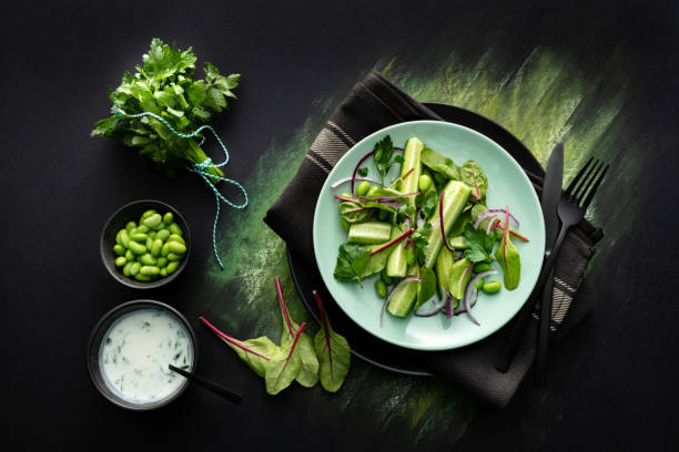 istock Salads: Salad with Cucumber, Lettuce, Soybeans, Parsley and Yoghurt Dressing 1436739747